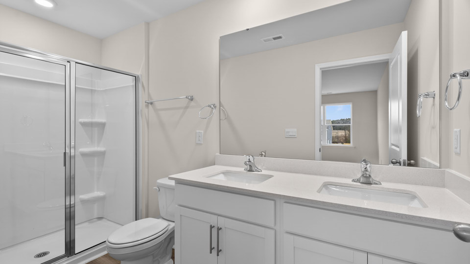 Primary bathroom with double sink and walk-in shower