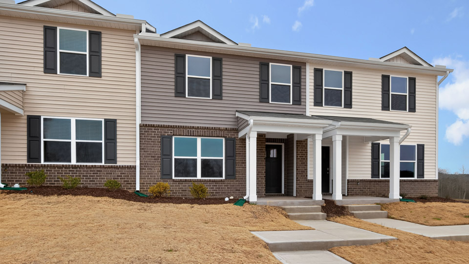 Two story town home with brown siding.