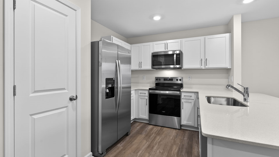 Kitchen with white cabinets and stainless steel appliances.
