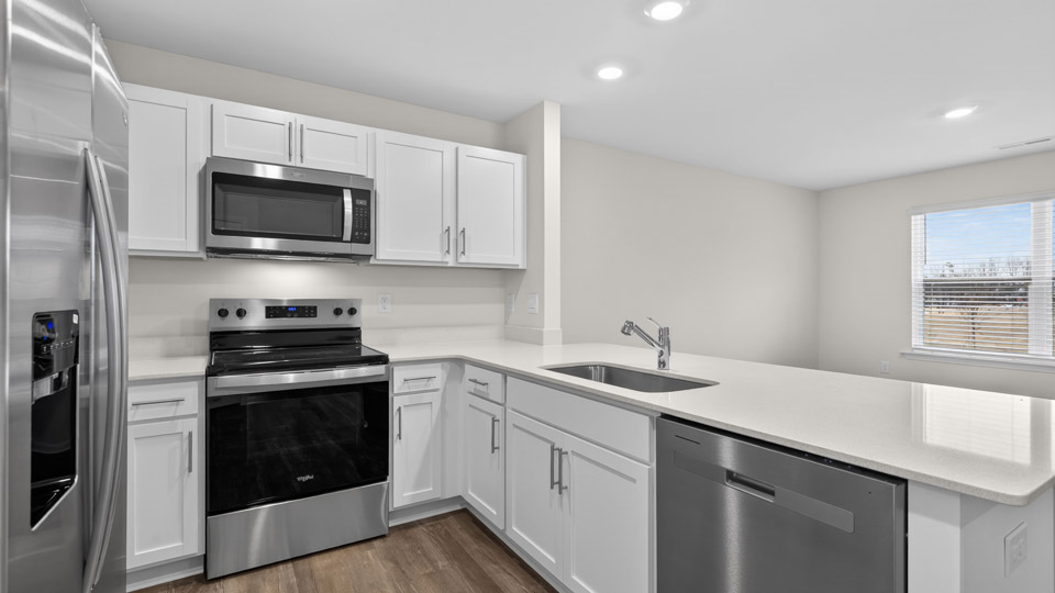 Kitchen with white cabinets and stainless steel appliances.