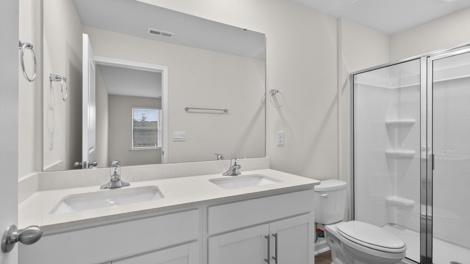 Primary bathroom with double sink and walk-in shower