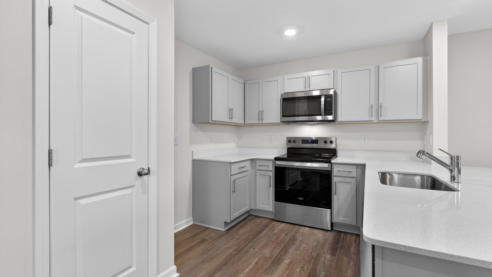 Kitchen with gray cabinets and stainless steel appliances.