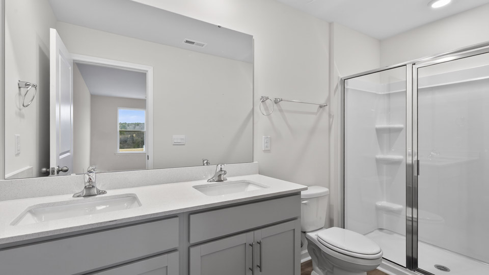 Primary bathroom with double sink and walk-in shower