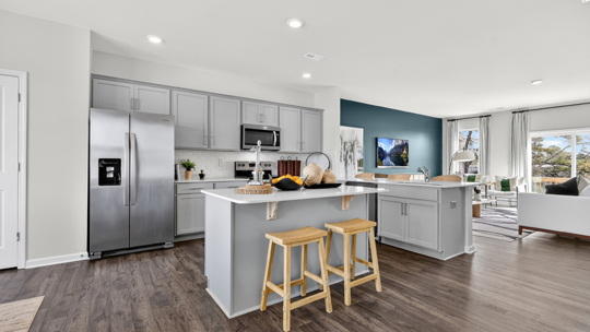 kitchen with gray cabinets quartz countertops and stainless steel appliances