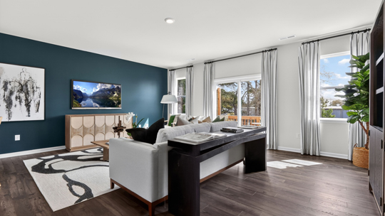 living room with natural lighting and revwood flooring