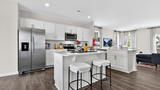 kitchen with white cabinets quartz countertops and stainless steel appliances