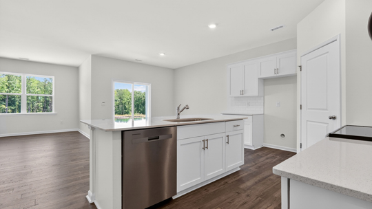 kitchen island with quartz countertops overlooking living room