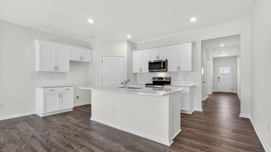 kitchen with white cabinets quartz countertops and island