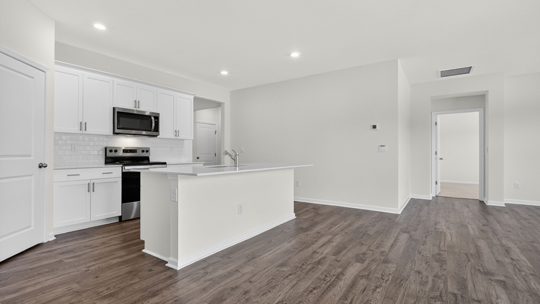kitchen with white cabinets quartz countertops and island
