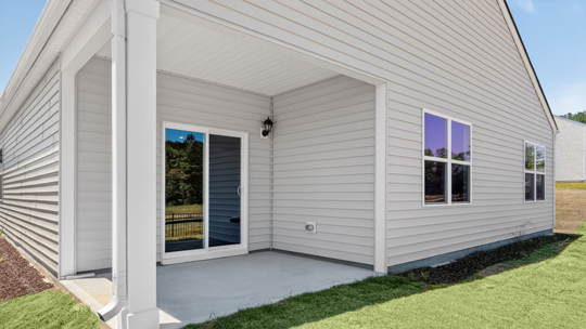 back of home with covered patio