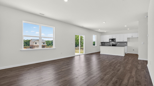 open concept living room overlooked by kitchen