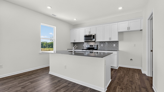 kitchen with island white cabinets and quartz countertops