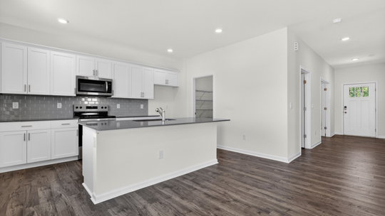kitchen with island white cabinets and quartz countertops
