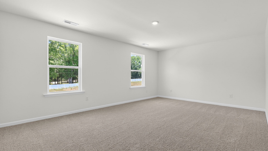primary bedroom with carpet flooring