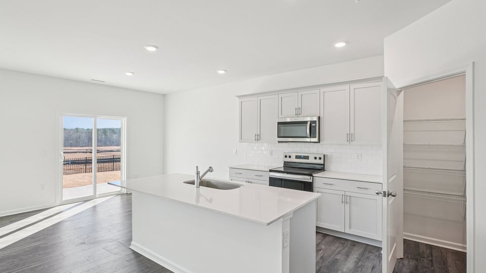 kitchen with white cabinets quartz countertops and kitchen island