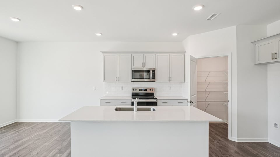 kitchen with white cabinets quartz countertops and kitchen island