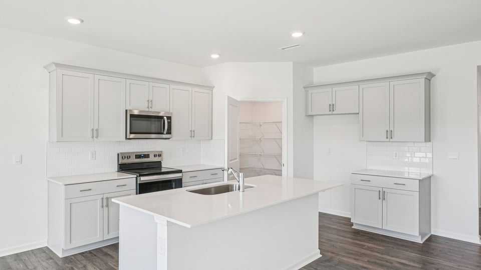 kitchen with white cabinets quartz countertops and kitchen island
