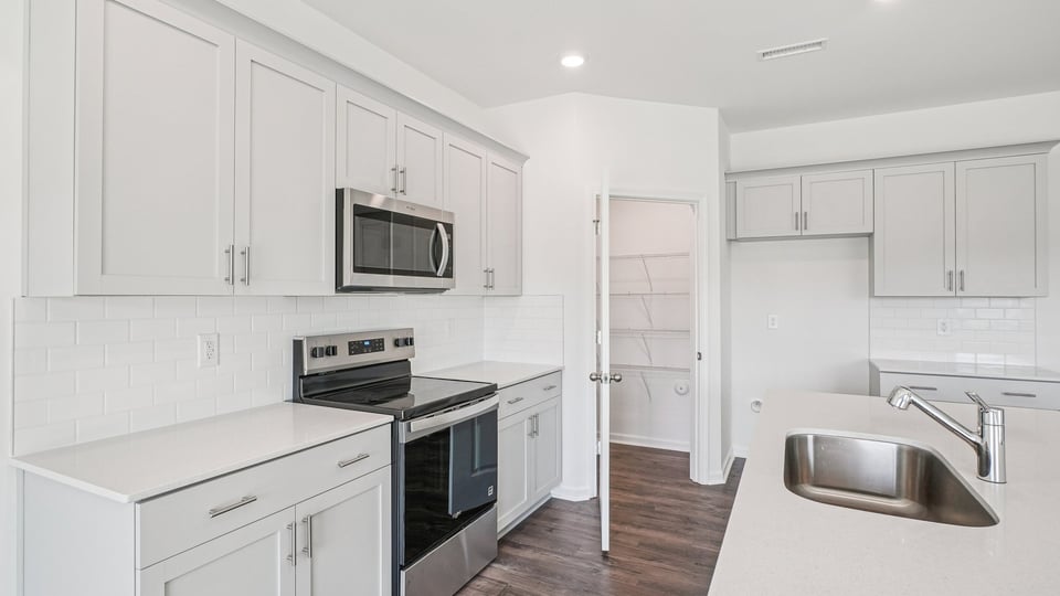 kitchen with white cabinets quartz countertops and kitchen island