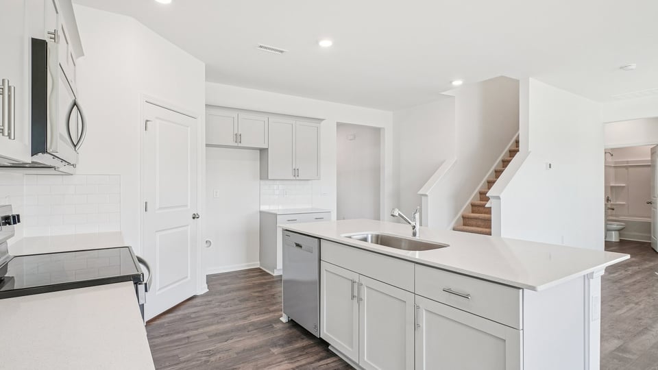 kitchen with white cabinets quartz countertops and kitchen island