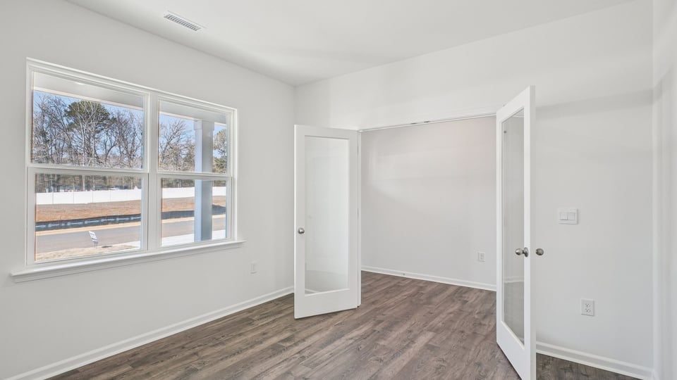 study with french glass doors and revwood flooring