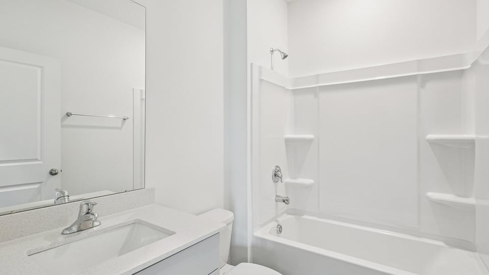 bathroom with tub shower combo and quartz countertops