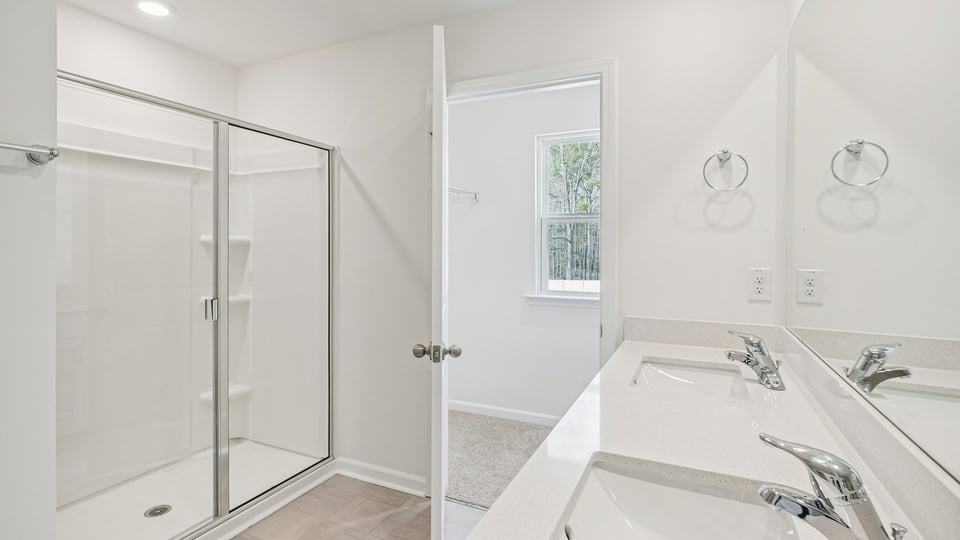 bathroom with quartz countertops and walkin glass door shower