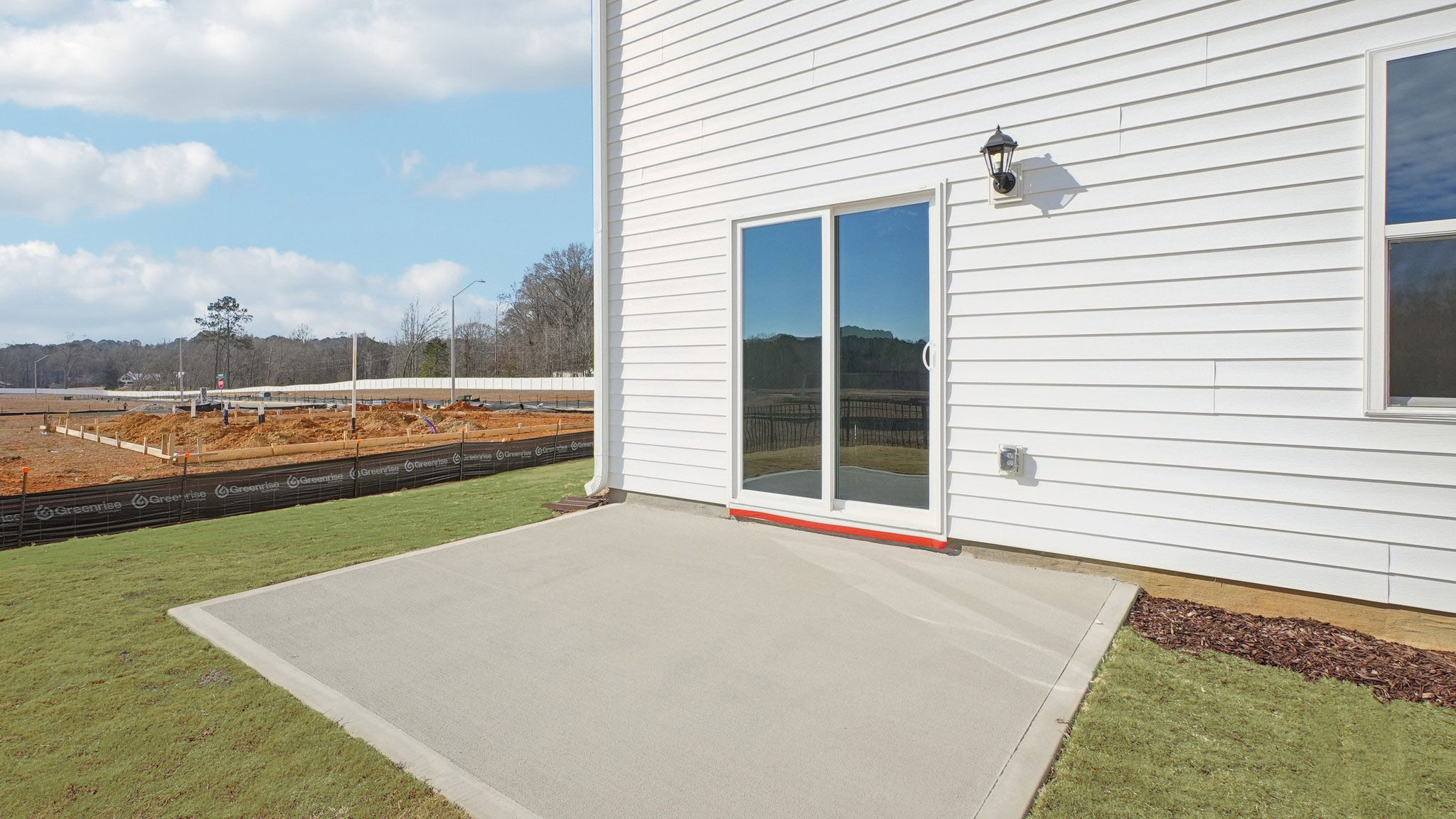concrete patio with sliding glass doors