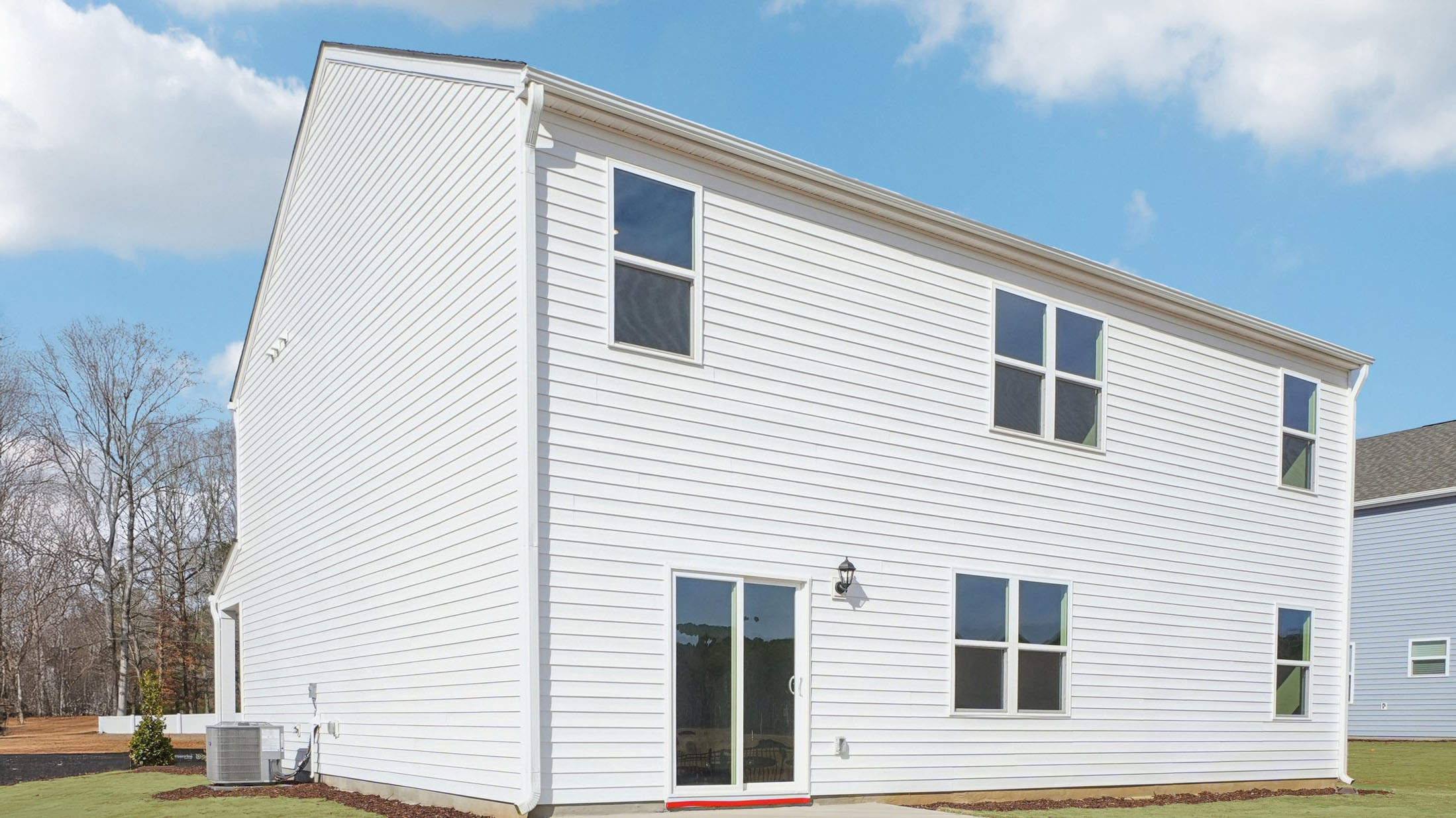back of home with concrete patio