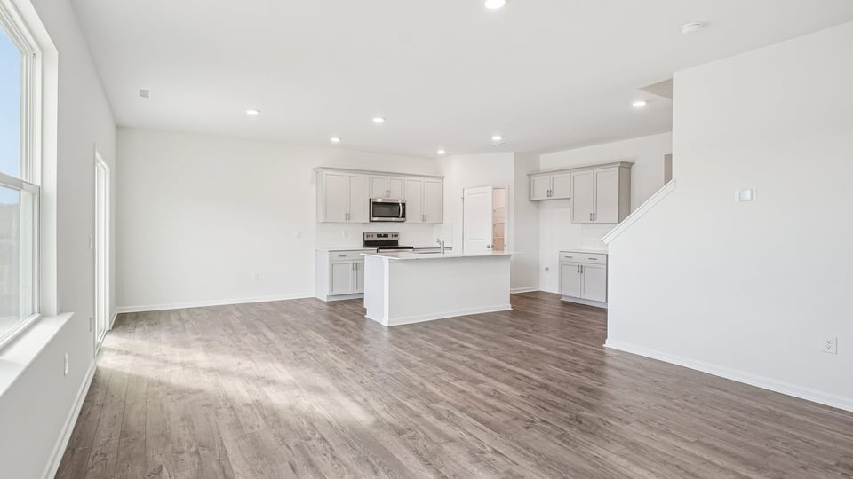 open concept living room with revwood flooring