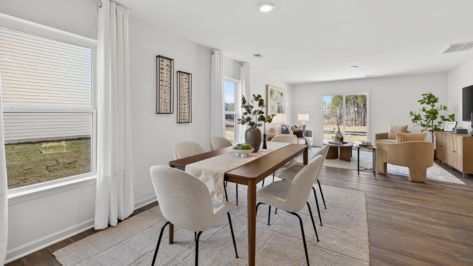 open concept dining and living areas off of kitchen