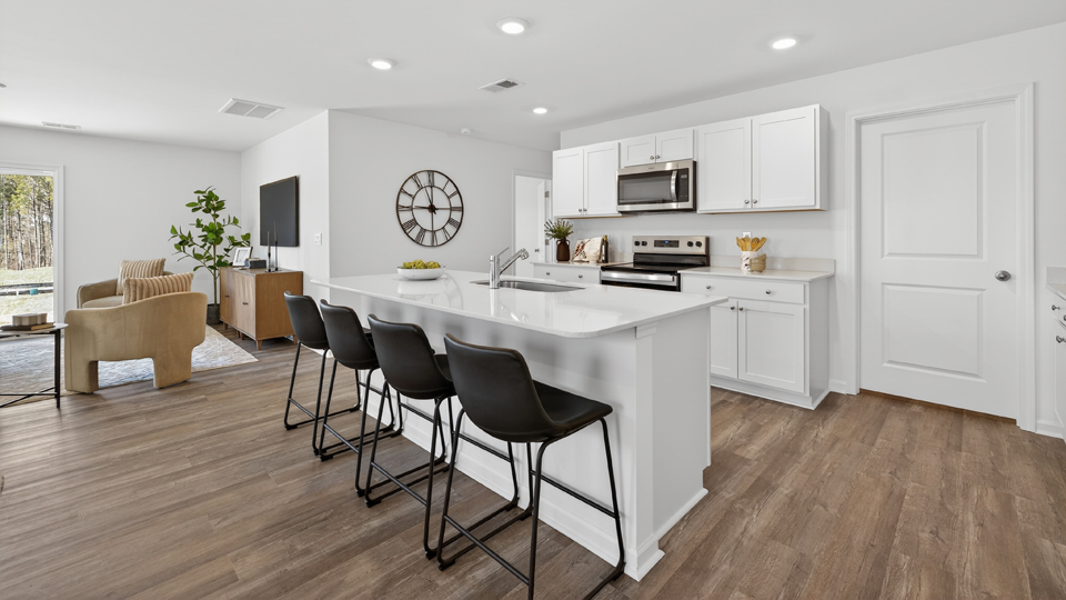 kitchen with white cabinets quartz countertops and revwood flooring
