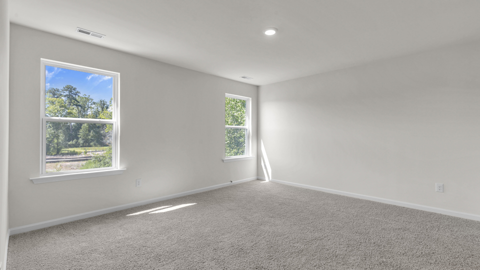 Primary bedroom with carpet flooring