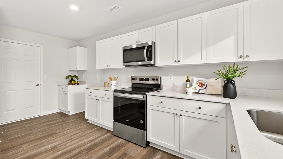 kitchen with white cabinets quartz countertops and stainless steel appliances
