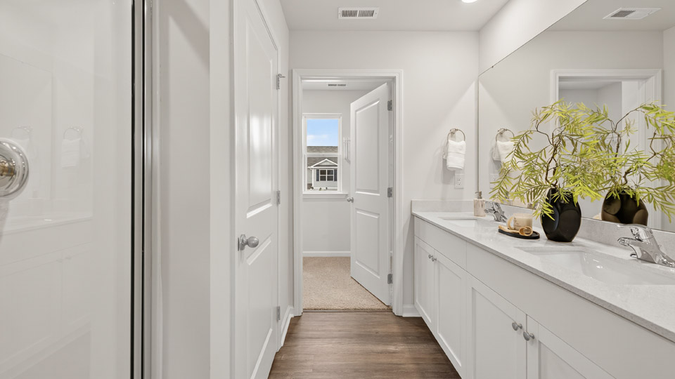 bathroom with white quartz countertops and white cabinets
