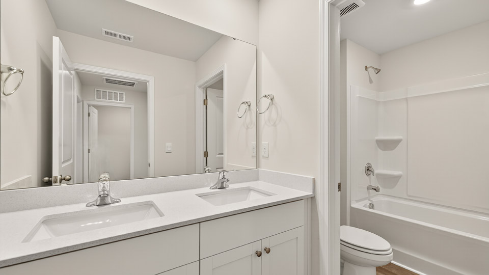 bathroom with white quartz countertops and tub shower combo