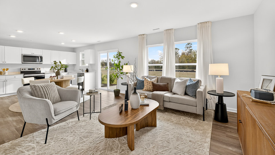 open concept living room overlooked by kitchen