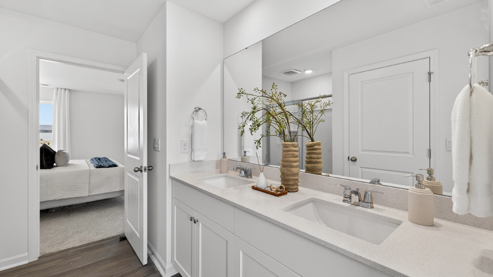 bathroom with dual vanity and quartz countertops