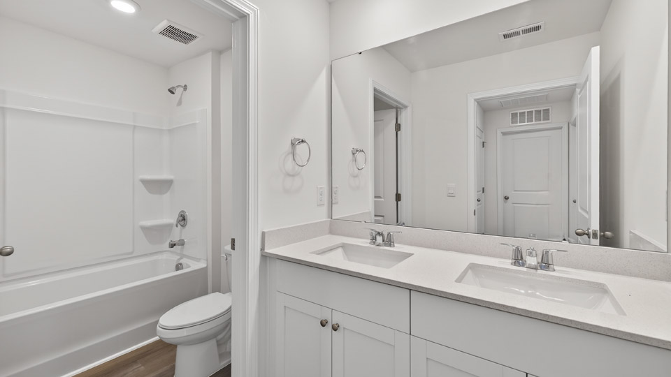 bathroom with tub shower combo and quartz countertops