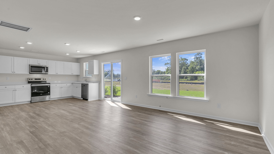 kitchen with quartz counters, kitchen island, pantry, stainless steel appliances
