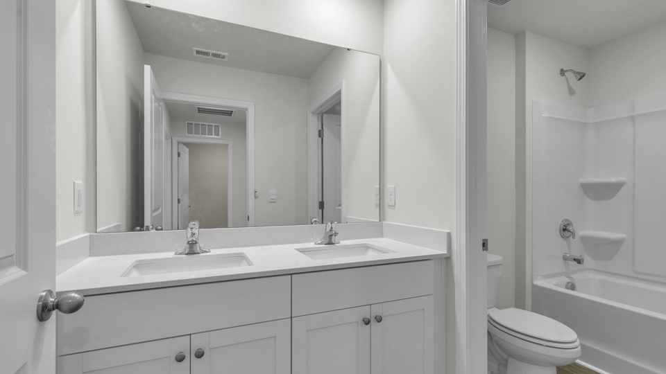 secondary bathroom with shower tub combo and single vanity sink