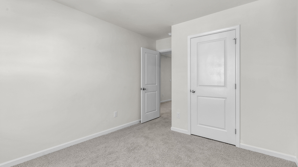 additional bedroom with window, carpeting, closet
