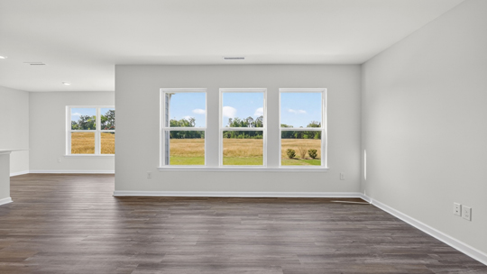 living room with lots of natural lighting and revwood flooring
