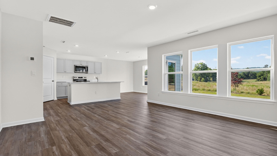 open concept living area overlooked by kitchen