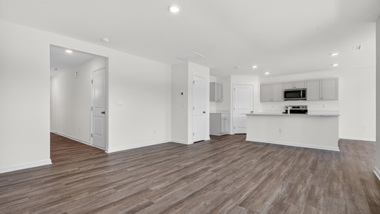 open concept living area overlooked by kitchen