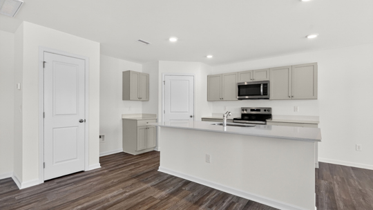 kitchen with island quartz countertops and gray cabinets
