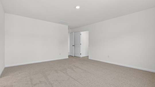 primary bedroom with carpet flooring