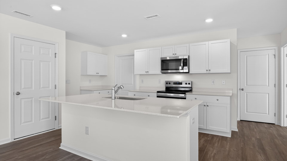 Kitchen with white cabinets and stainless steel appliances.