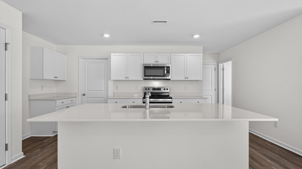 Kitchen with white cabinets and stainless steel appliances.