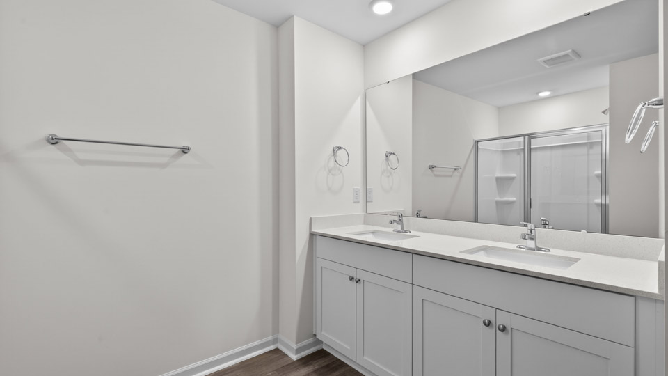 Primary bathroom with double sink and walk-in shower