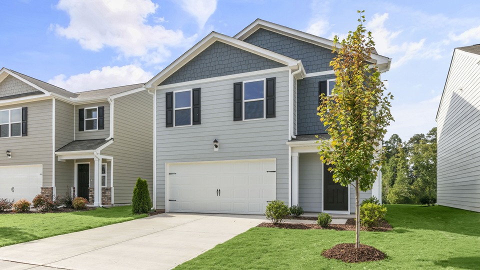 front exterior of robie floorplan with 2 car garage and driveway, gray and blue siding with blue shutters